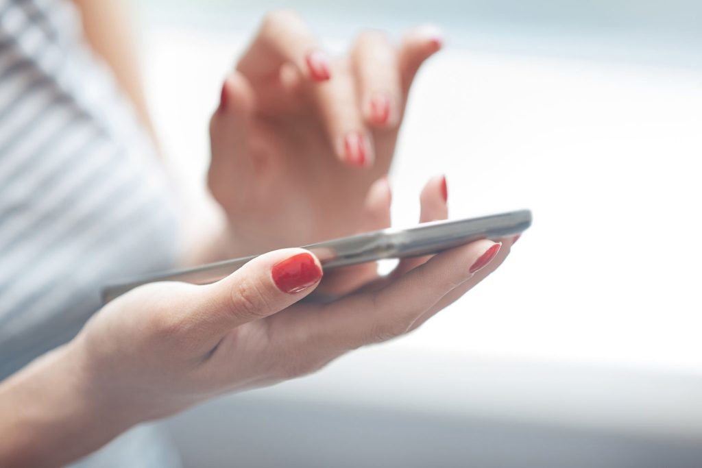 Satima skrolate po telefonu? Ovih 6 problema mnogi ne povezuju s tom navikom Ruke žene koja drži telefon i prstom skroluje po ekranu.